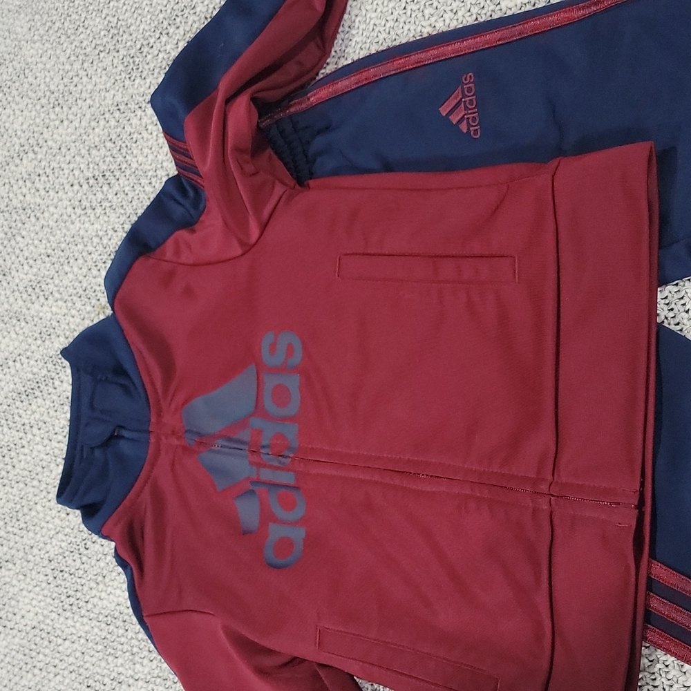 Adidas track suit zip up front long sleeve maroon and blue and pants.